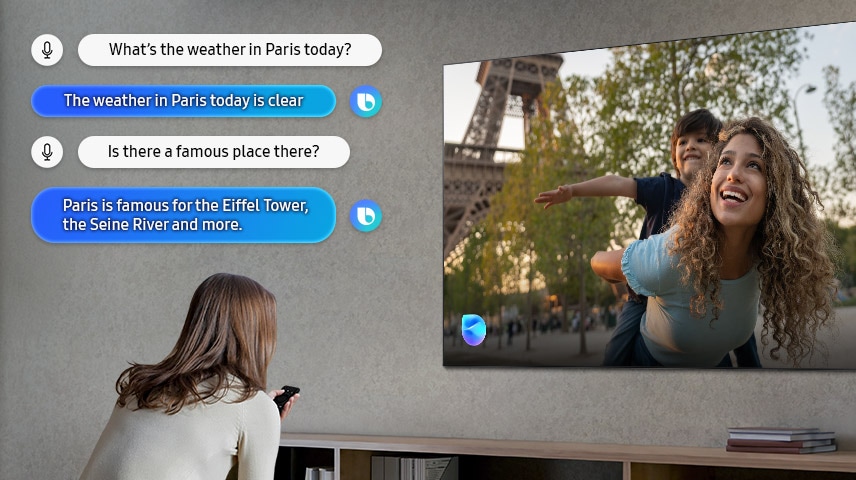 Woman in living room speaks to Bixby through the TV. Captions of the dialogue are shown. What’s the weather in Paris today? The weather in Paris today is clear. Is there a famous place there? Paris is famous for the Eiffel Tower, the Seine River and more.